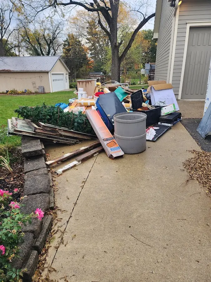 Dumpster being loaded with debris for Estate Cleanout Dumpster Rental in Vandalia